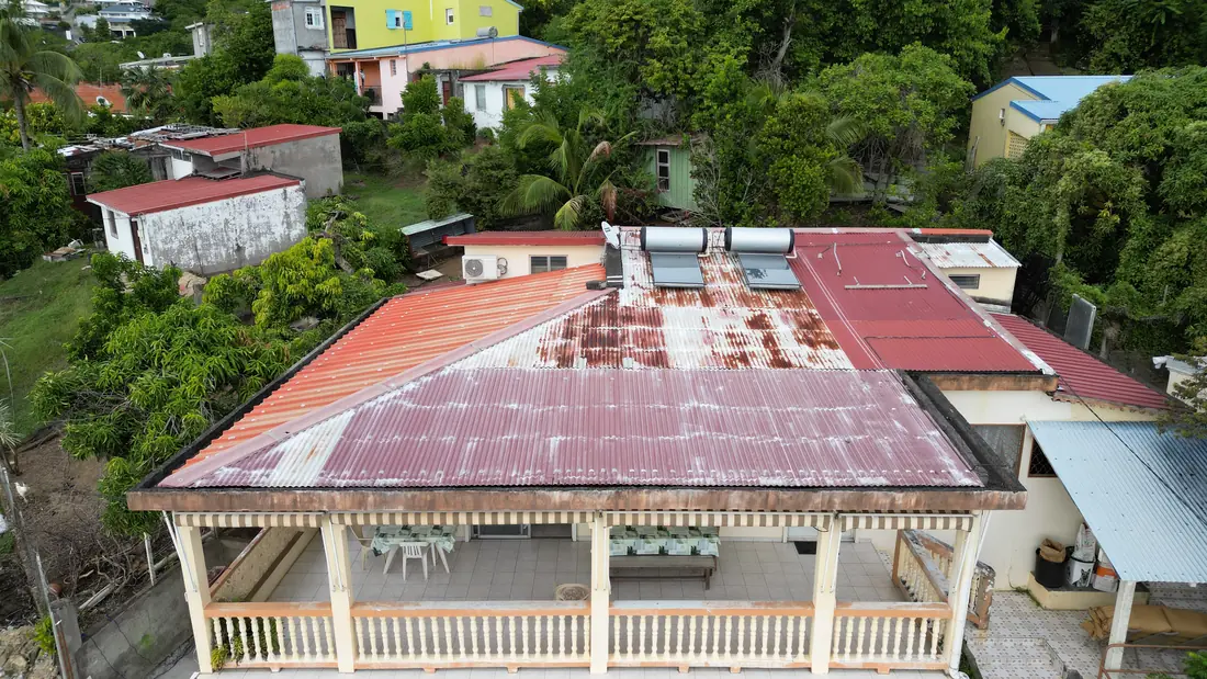 Chantier de toiture réalisé par Mes Primes Rénovations à Schœlcher : toiture sur les hauteurs, vue d'ensemble de la charpente couverte